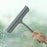 A bathroom shower squeegee for cleaning shower doors and car windows, an efficient surface cleaning tool.