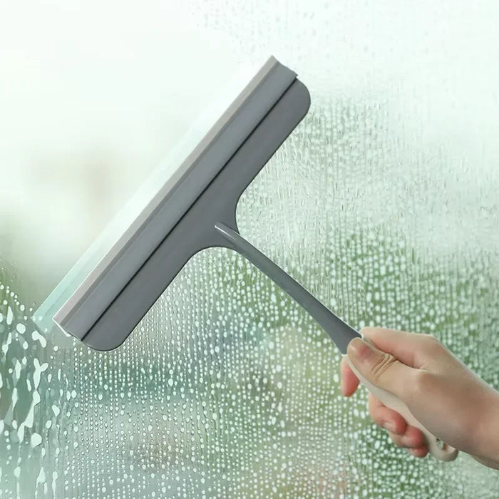 A bathroom shower squeegee for cleaning shower doors and car windows, an efficient surface cleaning tool.